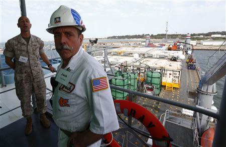 A U.S. merchant marine (R) officer and marine officer are seen in the U.S. MV Cape Ray ship docked at the naval airbase in Rota, near Cadiz, southern Spain April 10, 2014. REUTERS/Marcelo del Pozo