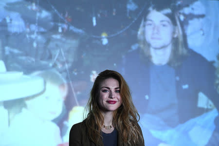 Kurt Cobain's daughter Frances Bean Cobain poses for a photograph in front of a home movie of Kurt at the opening of the 'Growing Up Kurt' exhibition featuring personal items of Nirvana frontman Kurt Cobain at the museum of Style Icons in Newbridge, Ireland, July 17, 2018. REUTERS/Clodagh Kilcoyne