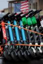 Scooters are shown stacked in a truck after the company impounded the devices after they were left on private property in San Diego, California