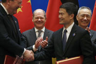 German Finance Minister Olaf Scholz, center, and Chinese Vice Premier Liu He, right, applaud as they witness a signing ceremony after the China-Germany High Level Financial Dialogue at the Diaoyutai State Guesthouse in Beijing, Friday, Jan. 18, 2019. (AP Photo/Andy Wong, Pool)