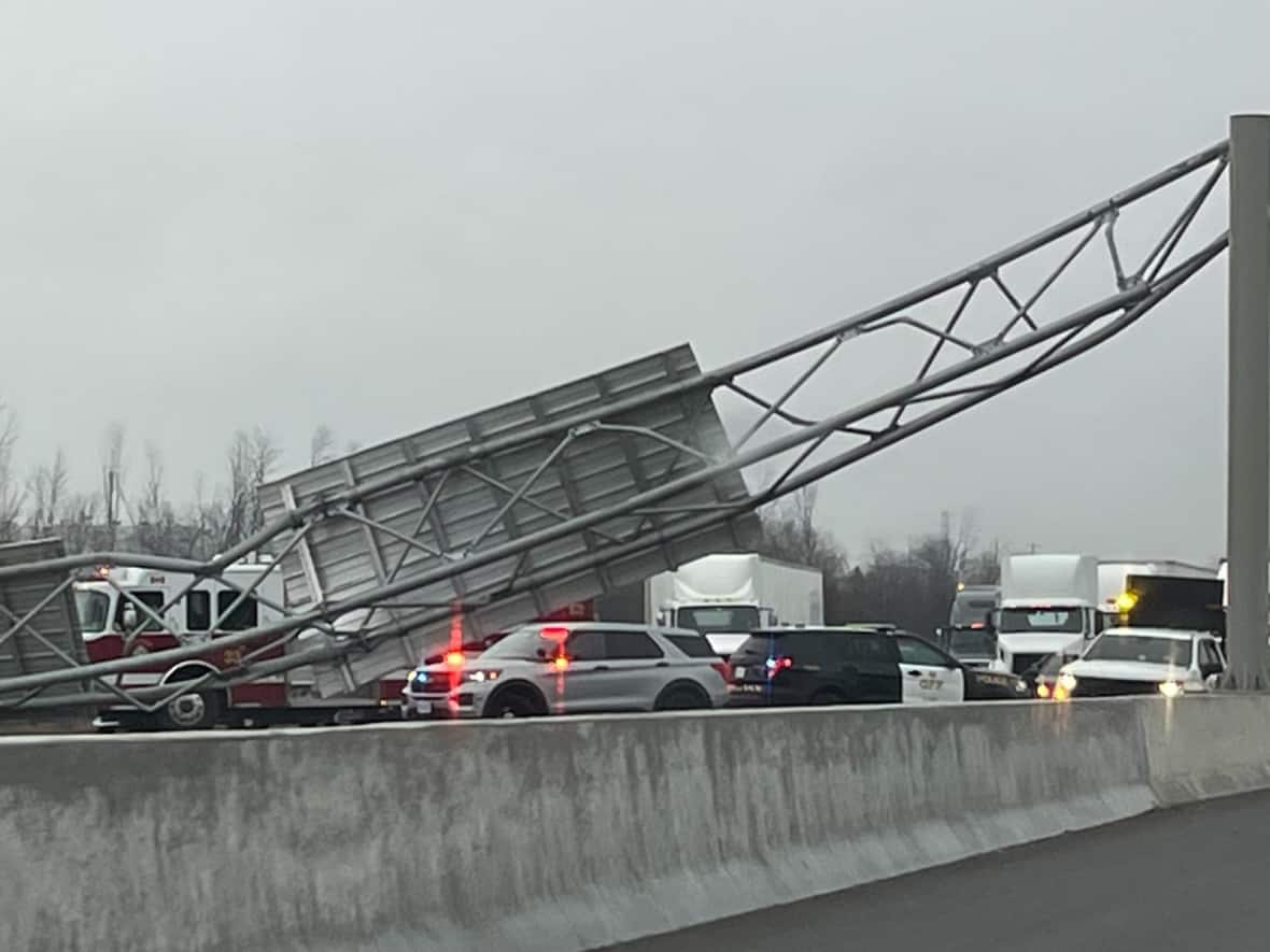 Police haven't said when they expect the sign structure to be removed from the highway. (Naomi Robinson/CBC News - image credit)