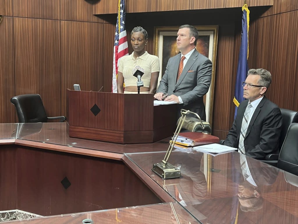 Latoreya Till (left), the mother of a 15-year-old girl who fell asleep in Detroit's 36th District Court Judge Kenneth King's courtroom during a field trip on Aug. 13, is suing the judge, according to her attorney James Harrington (center), as they speak at a news conference in Southfield, Mich., Wednesday, Aug. 21, 2024. (Kara Berg/Detroit News via AP)