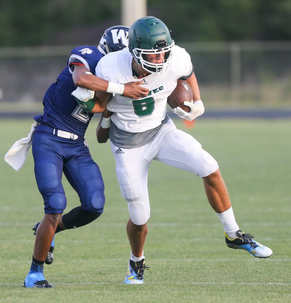 Seahawks WR Pearce Spurlin fights off a Braves defender during the South Walton Walton spring football scrimmage played at Walton High.