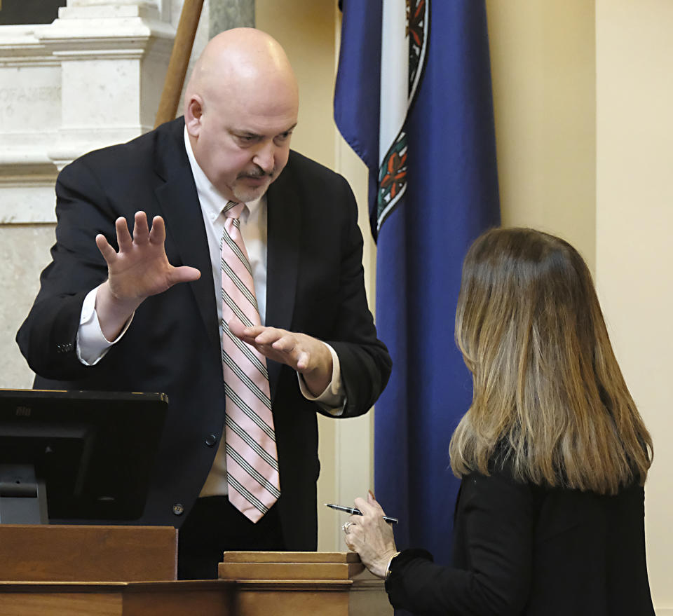 House Speaker Todd Gilbert, R-Shenandoah, left, talks with House Minority Leader Eileen Filler-Corn, D-Fairfax, right, in the House of Delegates Chamber inside the State Capitol in Richmond, Va. Friday, Feb. 11, 2022. Earlier, the House Republican leadership stated they would refuse to confirm any of the over 900 appointments to boards, etc., if the Senate would not take a vote on Andrew Wheeler to be appointed Secretary of Natural and Historic Resources. The Senate Democrats earlier dropped Wheeler's name from the list of the governor's cabinet secretaries, not even taking a vote on his position. (Bob Brown/Richmond Times-Dispatch via AP)