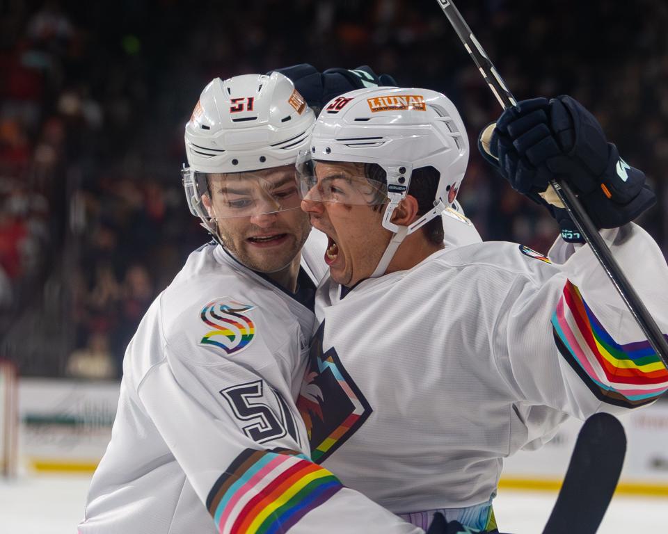 Connor Carrick (58) celebrates with a teammate after scoring a goal during the hockey game between the Coachella Valley Firebirds and Calgary Wranglers at Acrisure Arena in Palm Desert, California, on Friday, Jan. 19, 2024.