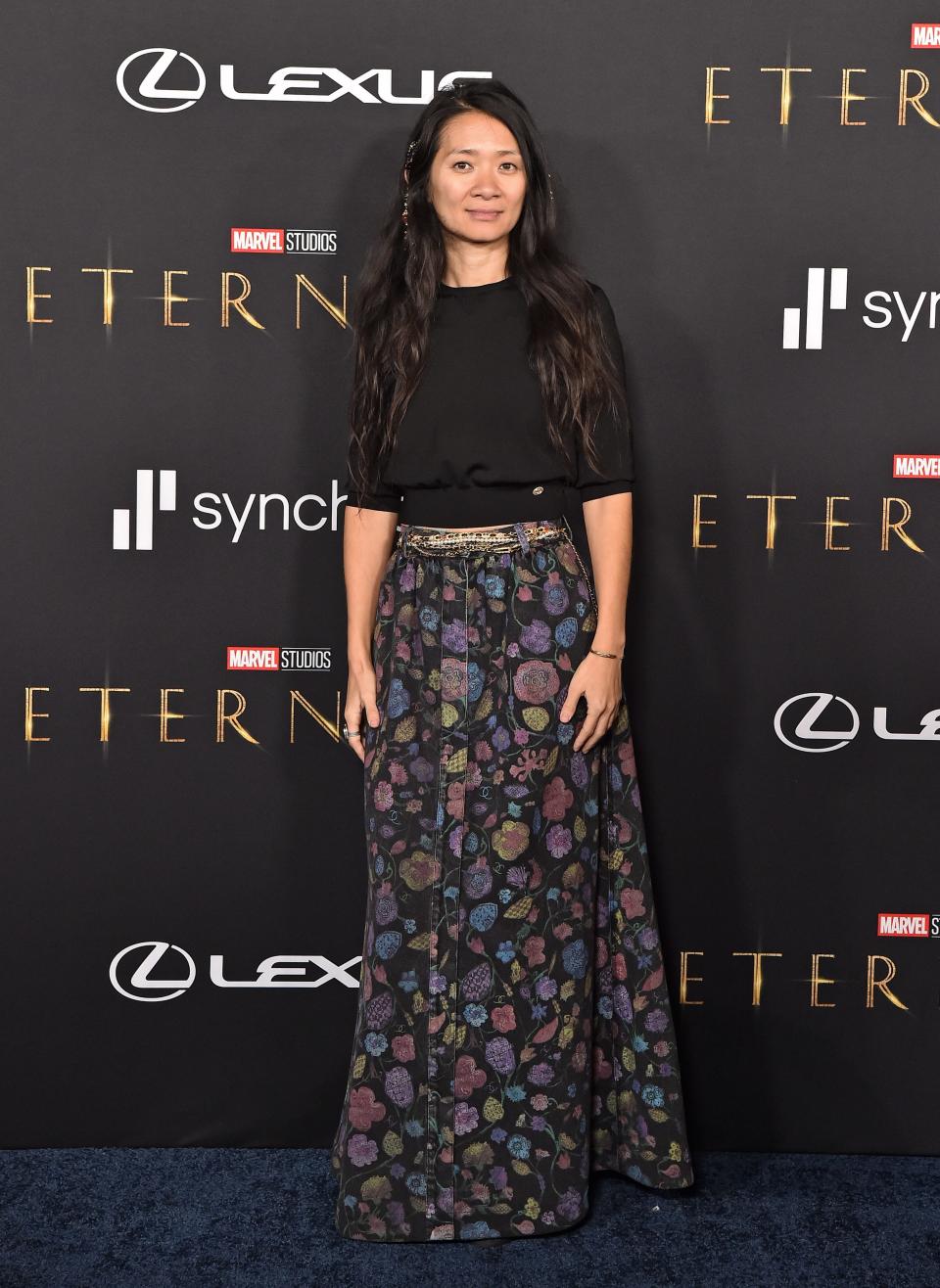 Chloe Zhao in a flower skirt and black top