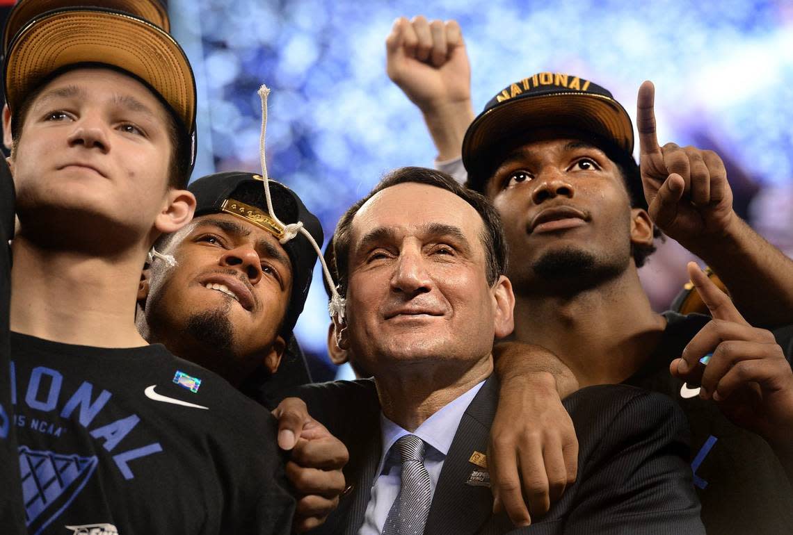 Duke head coach Mike Krzyzewski stands with, left to right, guard Grayson Allen (3), guard Quinn Cook (2) and forward Justise Winslow (12) as they watch “One Shining Moment” after Duke defeated Wisconsin 68-63 for the NCAA national championship in the Final Four at Lucas Oil Stadium at Indianapolis, Indiana, Monday, April 6, 2015.