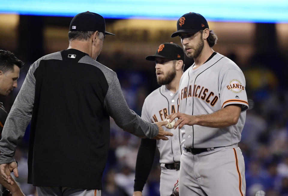 San Francisco Giants starting pitcher Madison Bumgarner, right, is taken out of the baseball game by manager Bruce Bochy during the fourth inning against the San Francisco Giants on Thursday, June 20, 2019, in Los Angeles. (AP Photo/Mark J. Terrill)