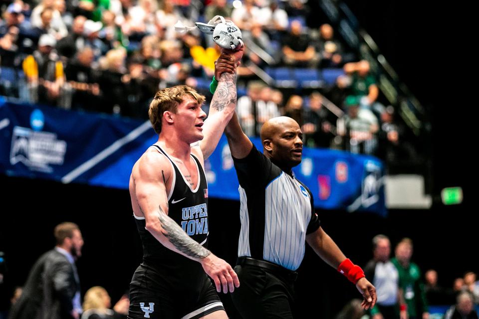 Upper Iowa's Chase Luensman has his hand raised after scoring a decision at 165 pounds in the semifinals of the NCAA Division II Wrestling Championships.