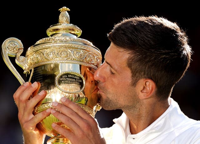 Novak Djokovic kisses the trophy after maintaining his stranglehold on Wimbledon. The Serbian beat a frustrated Nick Kyrgios 4-6 6-3 6-4 7-6 (3) to win a fourth consecutive title at the All England Club and a 21st grand slam crown. Another memorable centre court triumph was the highlight of a difficult year for Djokovic in which he was unable to compete at the Australian Open and the US Open due to his anti-vaccination stance