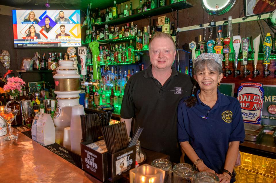 Owner Gary Belser, left, and manager Diana Tolentino pose behind the bar at Peoria Pizza Works, 3921 N. Prospect Road in Peoria Heights. The popular pizzeria is celebrating its 50th anniversary.