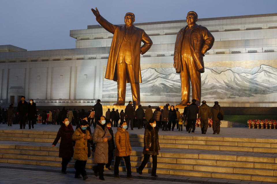 Citizens visit the bronze statues of their late leaders Kim Il Sung, left, and Kim Jong Il on Mansu Hill in Pyongyang, North Korea Thursday, Dec. 16, 2021, on the occasion of 10th anniversary of demise of Kim Jong Il. (AP Photo/Cha Song Ho)