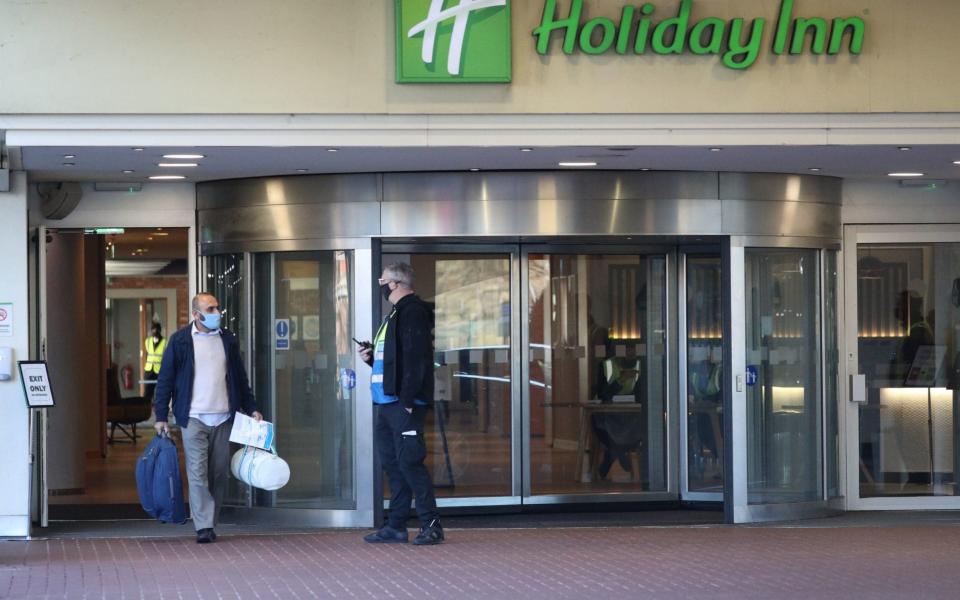 A guest leaves the Holiday Inn hotel near Heathrow Airport - Jonathan Brady/PA