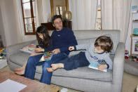 In this photo taken Thursday April 30, 2020 Kimkhi Nguyen plays on a sofa with his children Mila, 7, and Andre, 3, in Paris. As France prepares to start letting public life resume after eight weeks, many parents are deeply torn over a question without a clear or conclusive answer: Should I send my child back to school? The French government is easing some of the closure and home-confinement orders it imposed March 17 to curb coronavirus infections, with businesses permitted to reopen, residents cleared to return to workplaces and schools welcoming some students again starting Monday. (AP Photo/Oleg Cetinic)