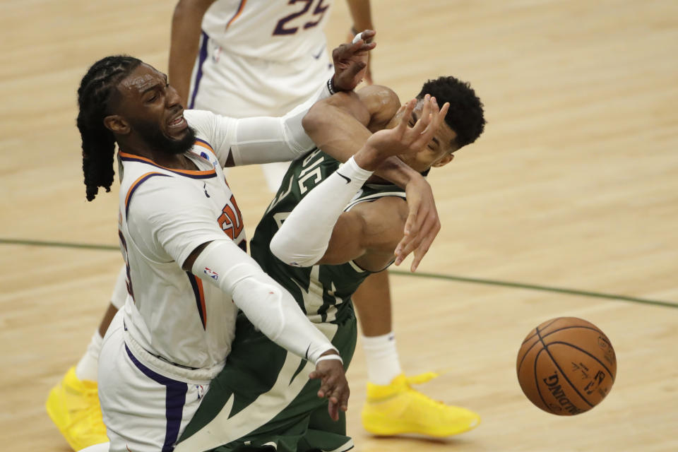 Milwaukee Bucks' Giannis Antetokounmpo, right, is fouled by Phoenix Suns' Jae Crowder, left, during the second half of Game 3 of basketball's NBA Finals, Sunday, July 11, 2021, in Milwaukee. (AP Photo/Aaron Gash)