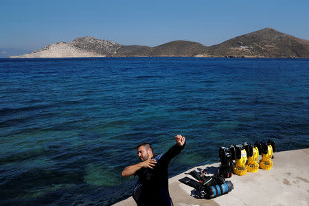 Diver Manos Mitikas, 35, prepares for a dive at a shipwreck site on the island of Fournoi, Greece, September 18, 2018. Picture taken September 18, 2018. REUTERS/Alkis Konstantinidis