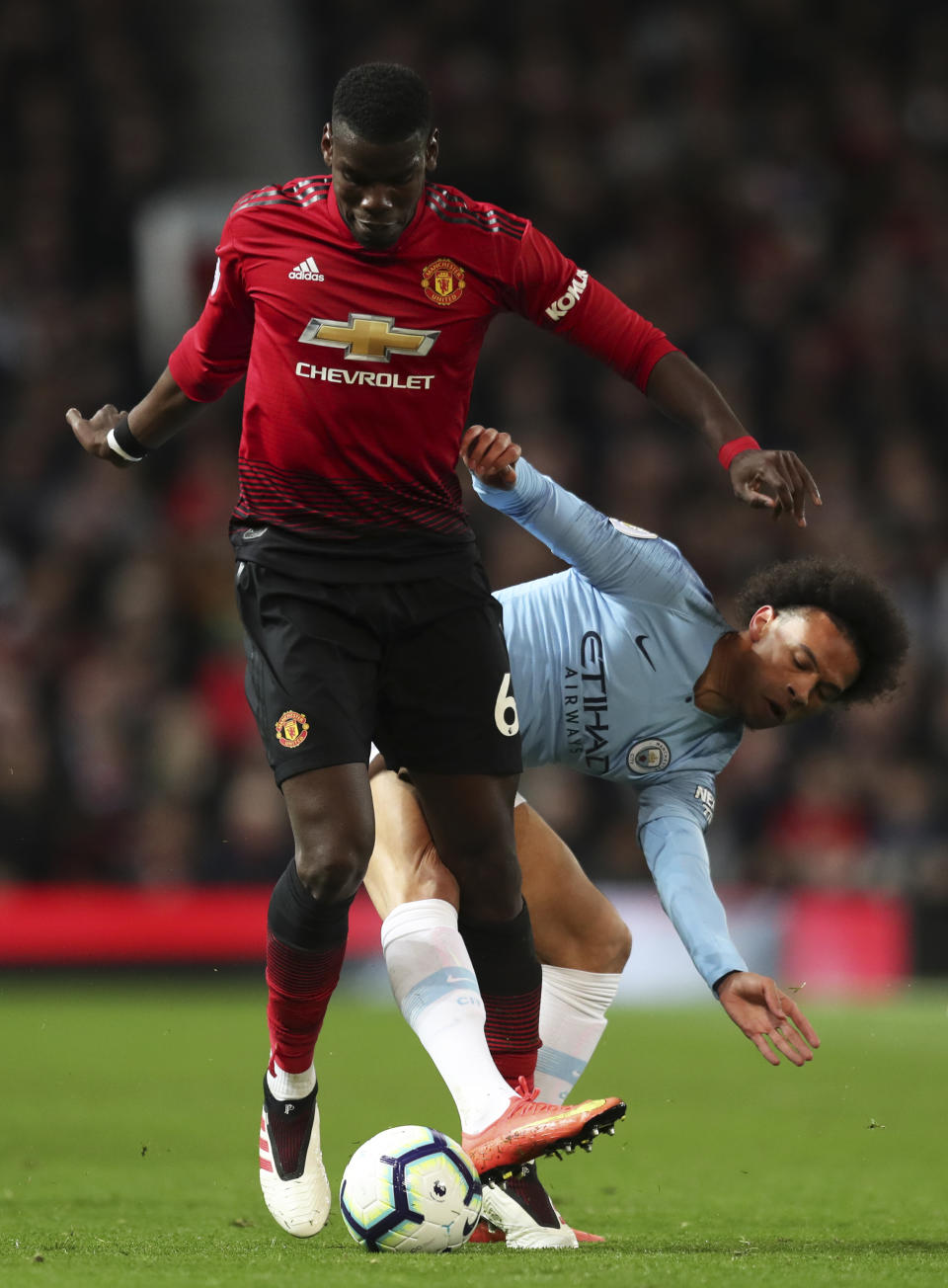 Manchester City's Leroy Sane fights for the ball with Manchester United's Paul Pogba, left, during the English Premier League soccer match between Manchester United and Manchester City at Old Trafford Stadium in Manchester, England, Wednesday April 24, 2019. (AP Photo/Jon Super)