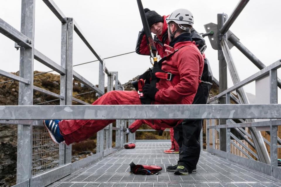 Strapping in: A thrillseeker prepares to head down a zip wire (Alamy)