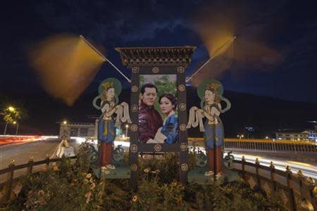 A portrait of Bhutan's King Jigme Khesar Namgyel Wangchuck and his fiancee Jetsun Pema is seen pictured in a roundabout in the capital Thimphu October 11, 2011. The Bhutanese king is scheduled to wed his fiancee Jetsun Pema over a three-day ceremony starting in the ancient capital Punakha on October 13. REUTERS/Adrees Latif