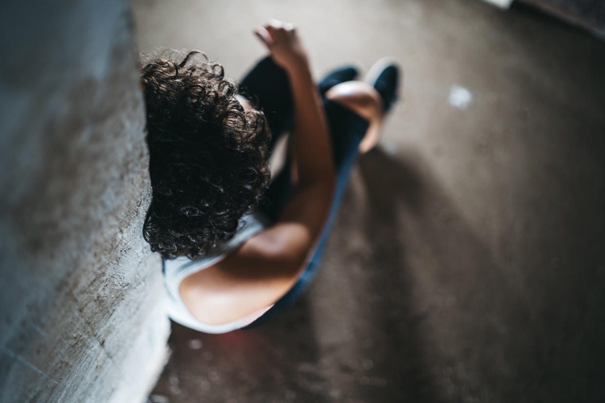 Loneliness helpless adolescence depressed  young caucasian woman sitting in abandoned house on a floor.