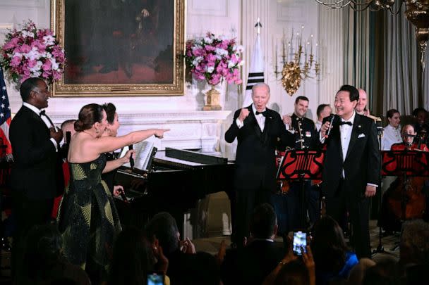 PHOTO: President Joe Biden and South Korean President Yoon Suk Yeol take the stage alongside singers at left, Norm Lewis, Jessica Vosk and Lea Salonga during a State Dinner at the White House, April 26, 2023. (Brendan Smialowski/AFP via Getty Images)