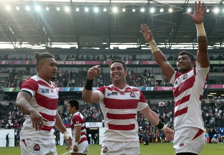 Japan's players celebrate after winning a Pool B match of the 2015 Rugby World Cup against Samoa at Stadium mk in Milton Keynes, north of London, on October 3, 2015