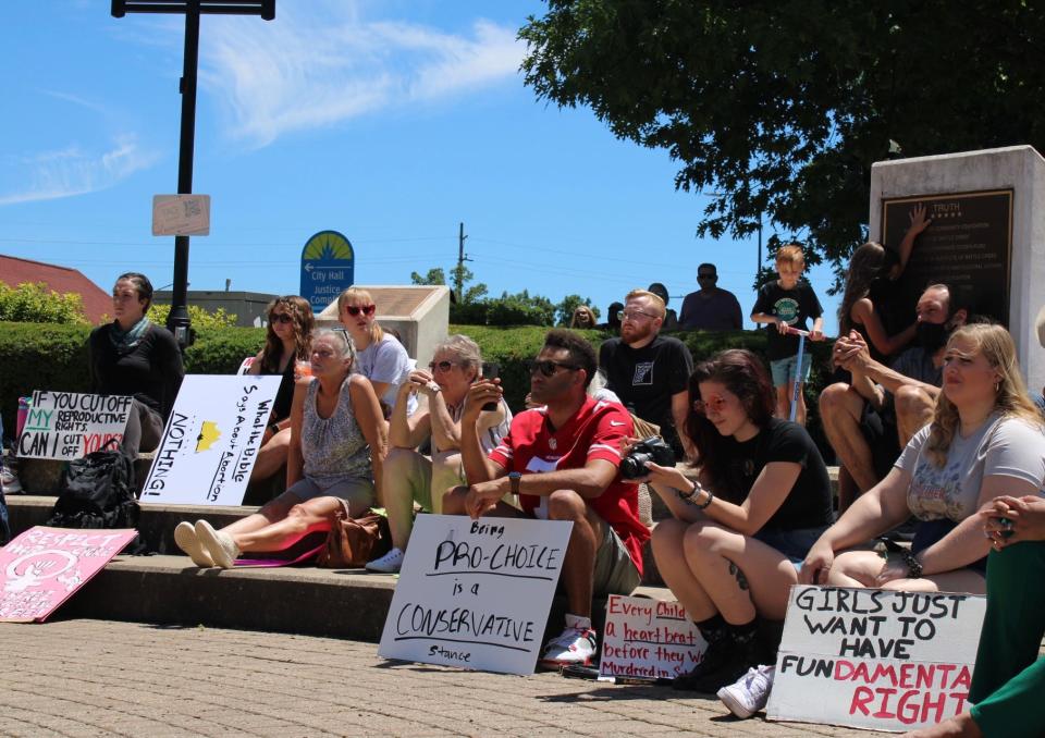 Protesters display signs advocating for abortion access and reproductive rights during a demonstration Saturday, July 9, 2022 at the Sojourner Truth Monument in Battle Creek, Michigan.