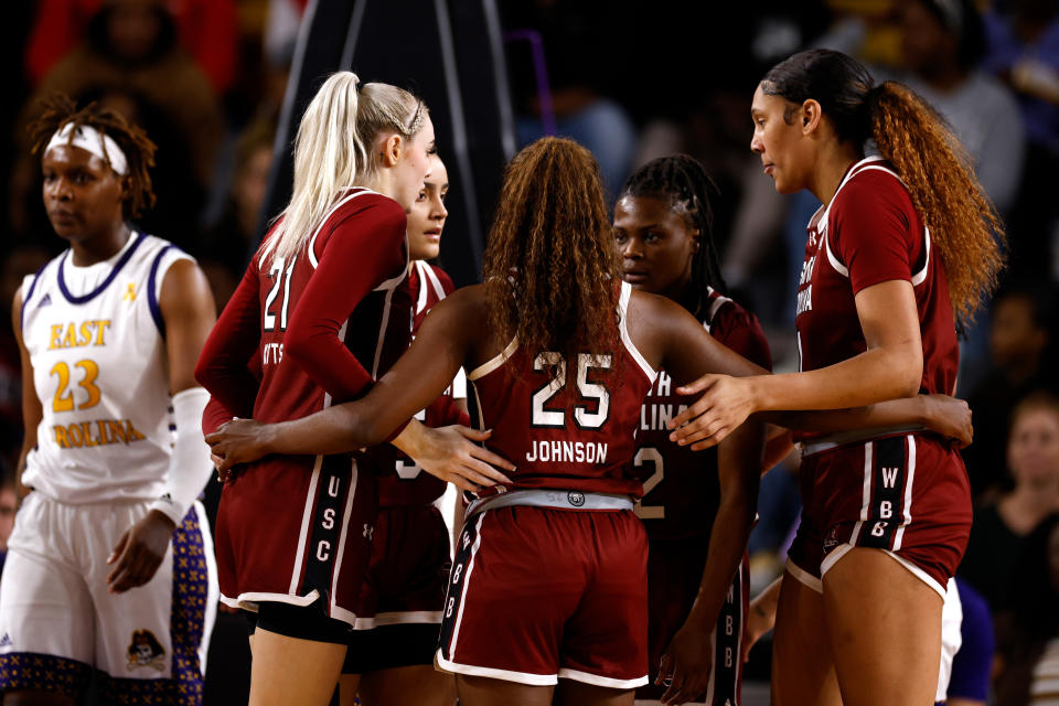 GREENVILLE, NORTH CAROLINA - DECEMBER 30: Chloe Kitts #21, Tessa Johnson #5, Raven Johnson #25, MiLaysia Fulwiley #12 and Kamilla Cardoso #10 of the South Carolina Gamecocks huddle during their game against the East Carolina Lady Pirates in Williams Arena at Minges Coliseum on December 30, 2023 in Greenville, North Carolina. SC won 73-36. (Photo by Lance King/Getty Images)