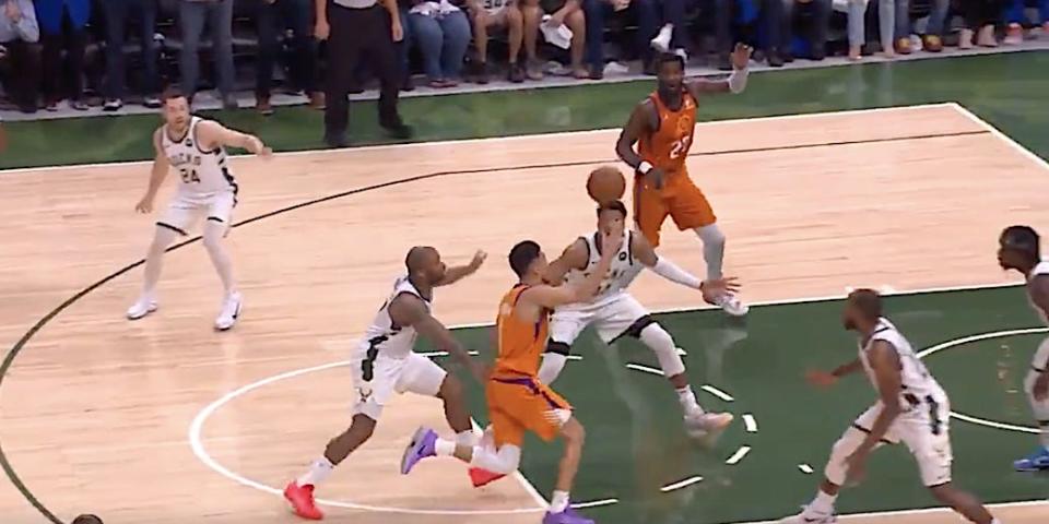 Giannis Antetokounmpo defends Devin Booker in Game 4 of the Finals.