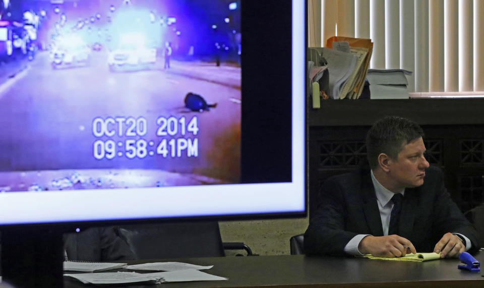 A police vehicle dash cam video of the moments after Laquan McDonald was fatally shot is displayed for jurors as Chicago police Officer Jason Van Dyke attends his first degree murder trial for the shooting death of McDonald, at the Leighton Criminal Court Building Wednesday, Oct. 3, 2018, in Chicago. (John J. Kim/ Chicago Tribune via AP, Pool)