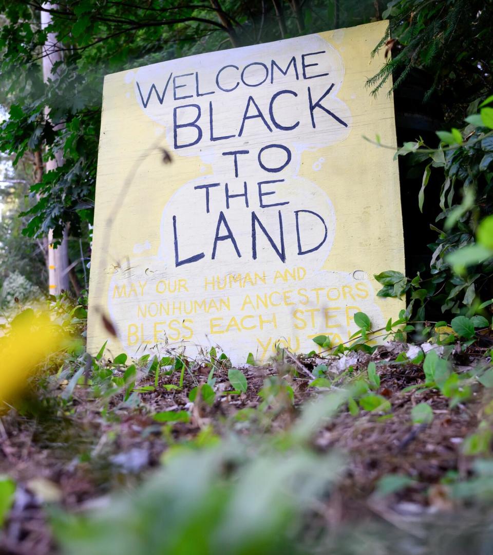 A sign stands at the entrance of EARTHseed Farm.