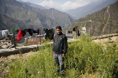 Toyanath Rijal, a telecoms engineer who survived the massive landslide triggered by last week's earthquake in Langtang village, poses for a photograph in Dhunche, Nepal, May 5, 2015. REUTERS/Olivia Harris