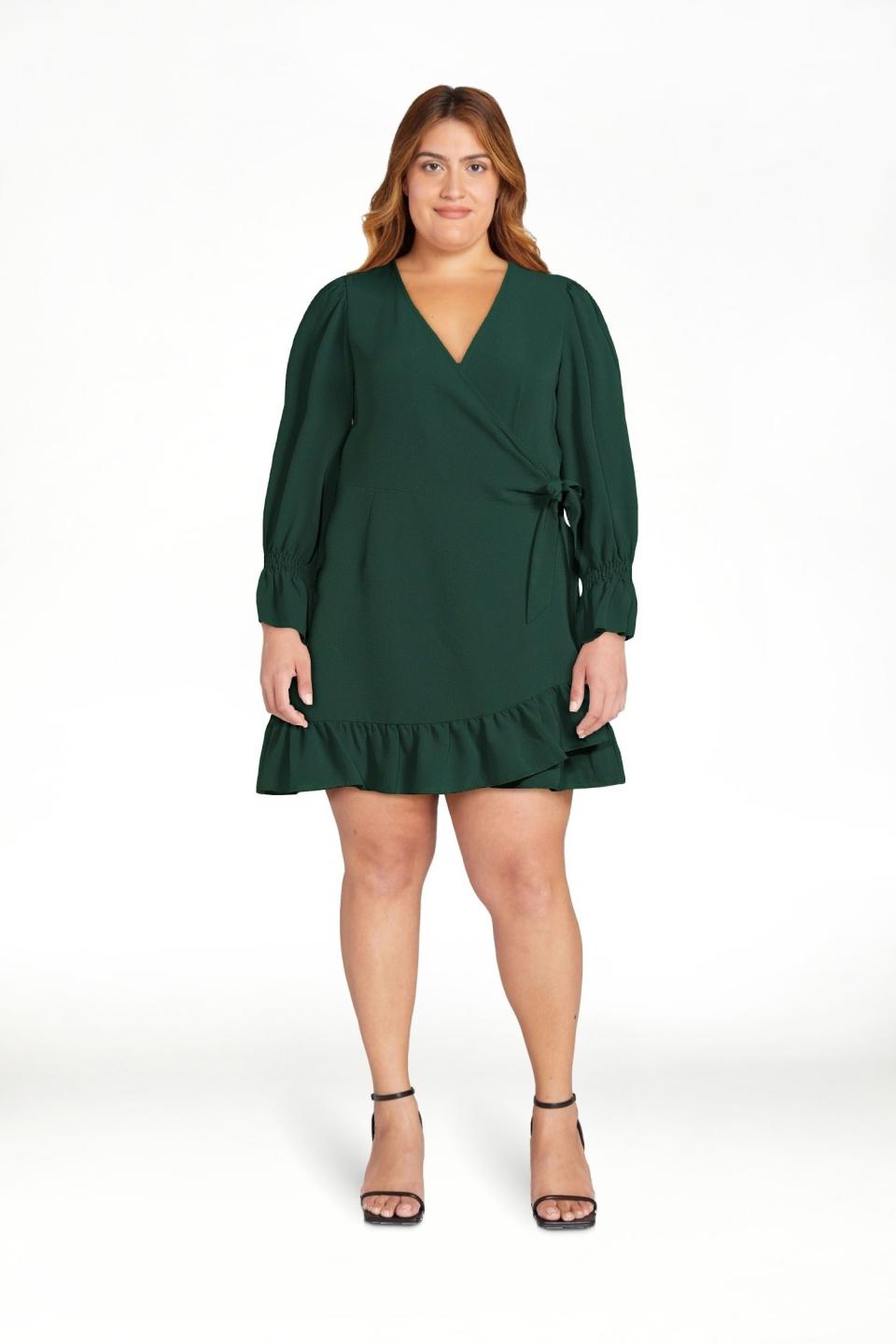 model in a green V-neck dress with a tie waist and ruffled hem, paired with black heels