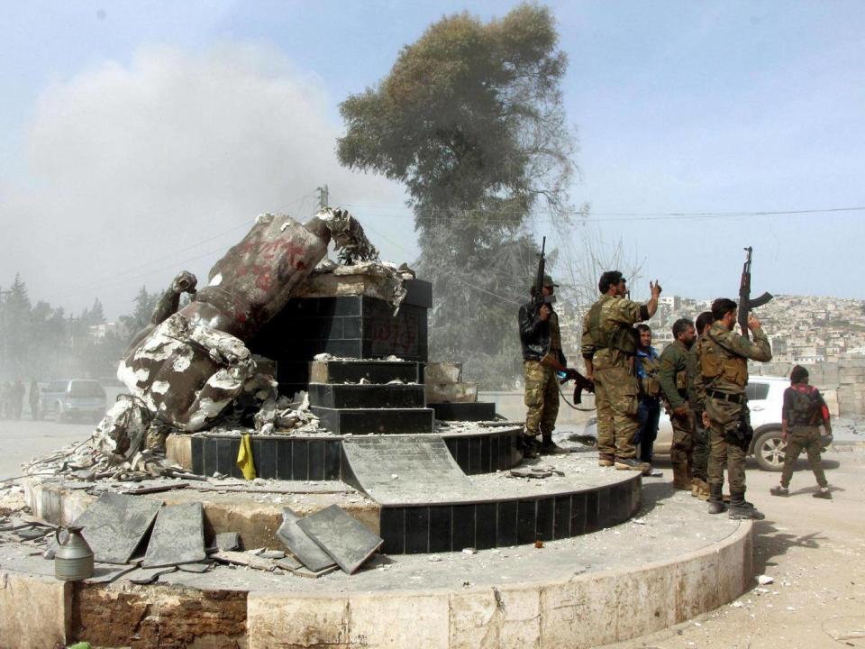 Soldiers destroy the statue (Hasan Kormozitao/DHA-Depo Photos via AP)