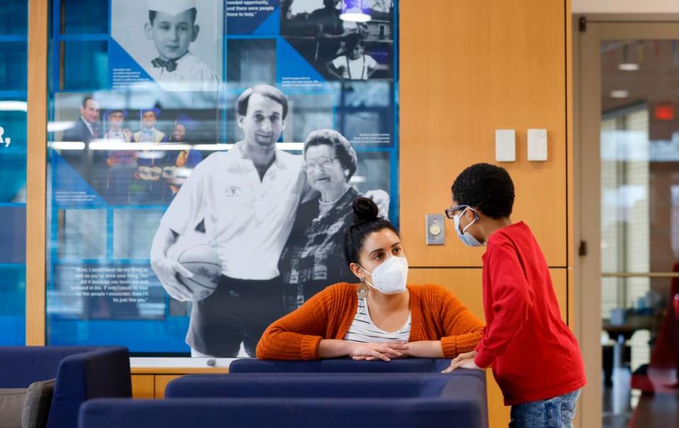 Cecily Jobe, lead tutor, talks with Kaleb Blue at the Emily K Center in Durham, N.C., Thursday, Feb. 24, 2022.