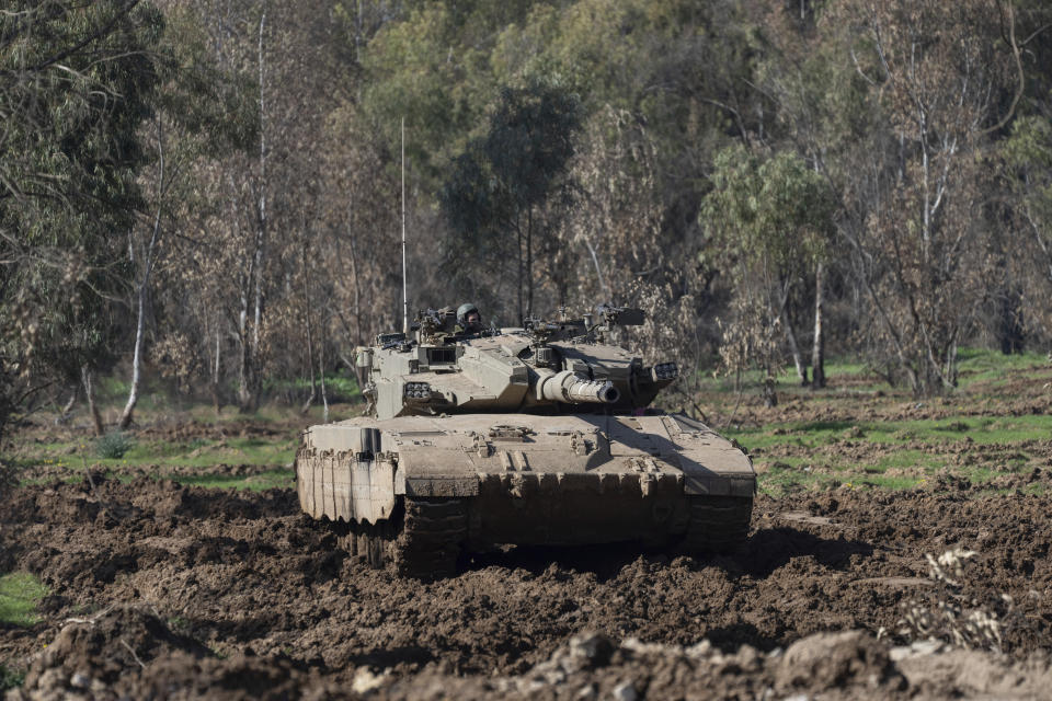 Israeli army tank moves near the Israeli-Gaza border, in southern Israel, Thursday, Jan. 18, 2024. The army is battling Palestinian militants across Gaza in the war ignited by Hamas' Oct. 7 attack on Israel. (AP Photo/Ohad Zwigenberg)
