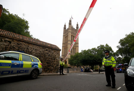 Police officers stand at a cordon after a car crashed outside the Houses of Parliament in Westminster, London. REUTERS/Hannah McKay