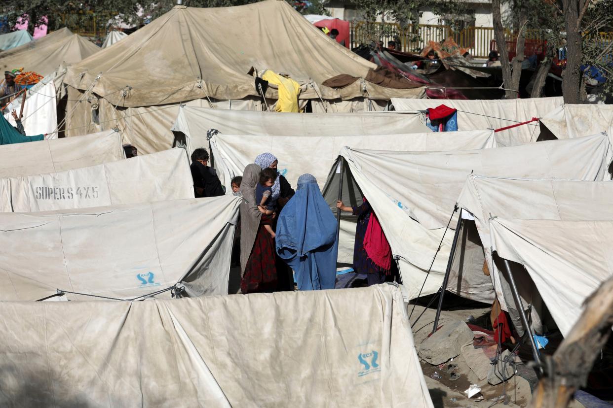Internally displaced Afghans from northern provinces, who fled their home due to fighting between the Taliban and Afghan security personnel, take refuge in a public park in Kabul, Afghanistan, Friday, Aug. 13, 2021.