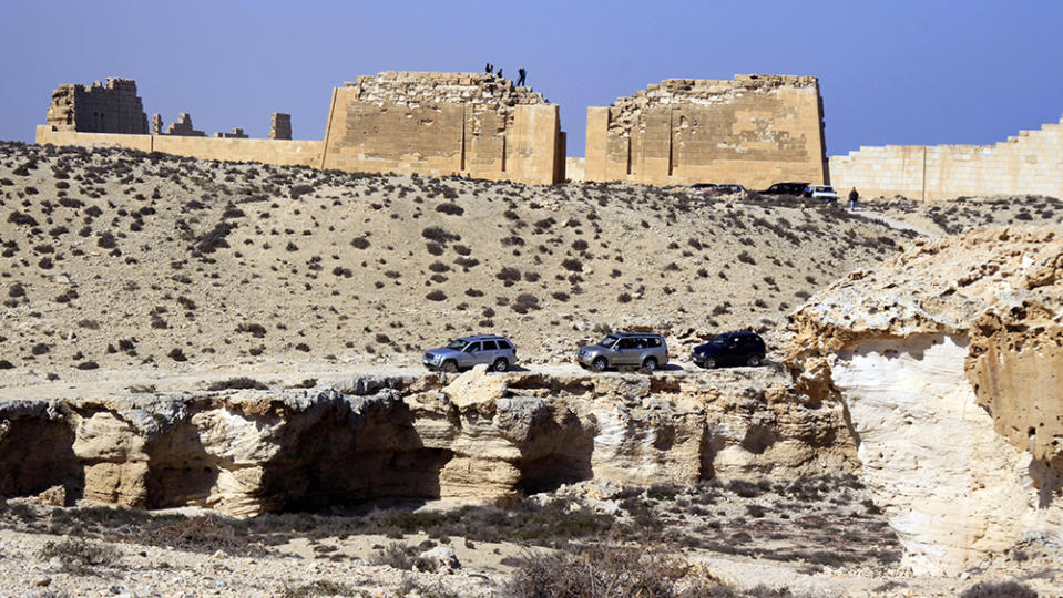 A convoy leaves the temple of Taposiris Magna, which was built during the reign of King Ptolemy II (282-246 B.C.), in Burg Al Arab, west of Alexandria, Egypt, Sunday, April 19, 2009, where archaeologists will begin excavating three sites in Egypt near the Mediterranean Sea that may contain the tombs of doomed lovers, Cleopatra and Mark Anthony. (AP Photo/Amr Nabil)