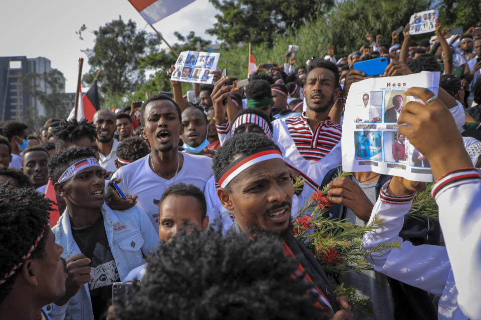 Oromos protest against the government and call for the release of prominent opposition figure Jawar Mohammed and others, seen on placards, during the annual Irreecha festival in the capital Addis Ababa, Ethiopia, Saturday, Oct. 2, 2021. Ethiopia's largest ethnic group, the Oromo, on Saturday celebrated the annual Thanksgiving festival of Irreecha, marking the end of winter where people thank God for the blessings of the past year and wish prosperity for the coming year. (AP Photo)