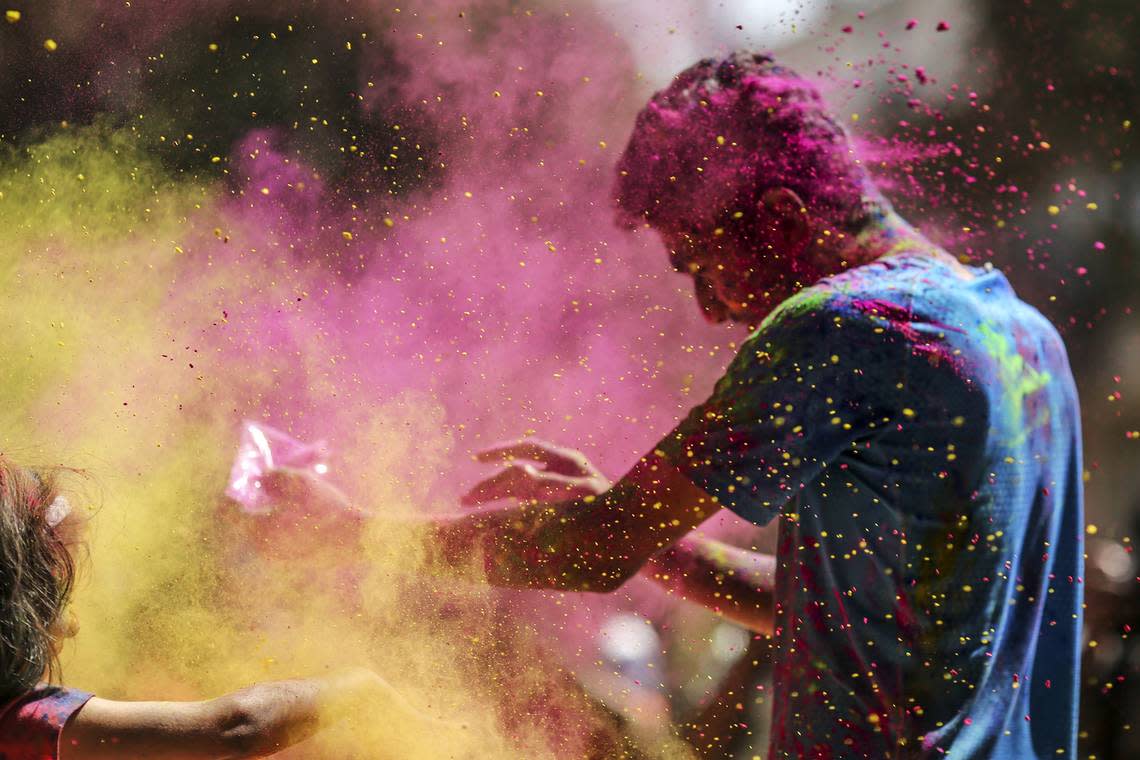 Colored powders are thrown in the air during Holi celebrations in Mumbai, India, on March 13, 2017.