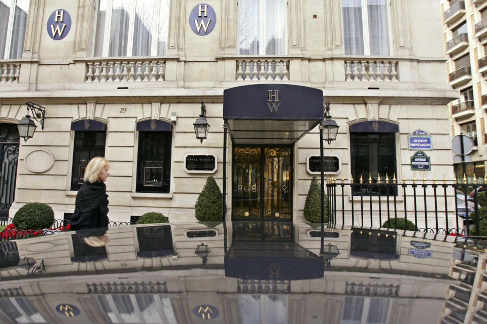 FILE - In this Friday Dec. 5, 2008 file photo, a woman walks past the Harry Winston jewelry store near the Champs-Elysees in Paris. Christmas shoppers strolled outside the posh Harry Winston jewelry shop near Paris' famed Champs-Elysees in 2008, armed thieves, some dressed as women and wearing wigs, entered the store and stole gems and jeweled watches worth up to $85 million. A brazen burglary on Monday Nov. 25, 2019 from Dresden’s Green Vault, one of the world’s oldest museums, holding priceless treasures is another in a long history of daring European heists over the years. (AP Photo/Francois Mori, File)