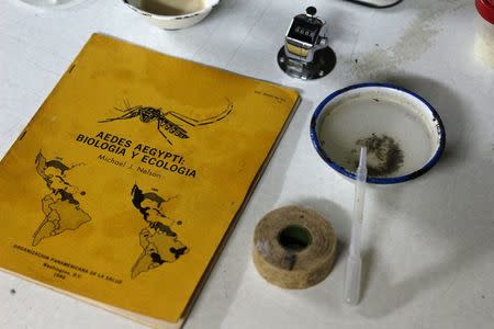 A book about Aedes aegypti mosquito is seen next to larvae in a laboratory conducting research on preventing the spread of the Zika virus and other mosquito-borne diseases, at the entomology department of the Ministry of Public Health in Guatemala City, February 4, 2016. REUTERS/Josue Decavele