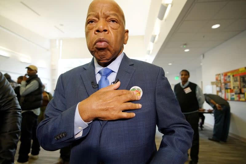 FILE PHOTO: U.S. Democratic Representative John Lewis puts on his "I'm Georgia Voter" sticker after casting a ballot in midterm election at Wolf Creek Library in Atlanta, Georgia