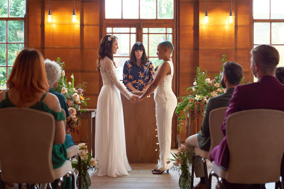 Two women stand at the altar about to be married