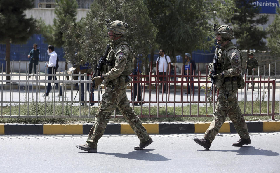 FILE- in this Thursday, Sept. 5, 2019 file photo, British soldiers with NATO-led Resolute Support Mission forces arrive at the site of a car bomb explosion in Kabul, Afghanistan, (AP Photo/Rahmat Gul, file)