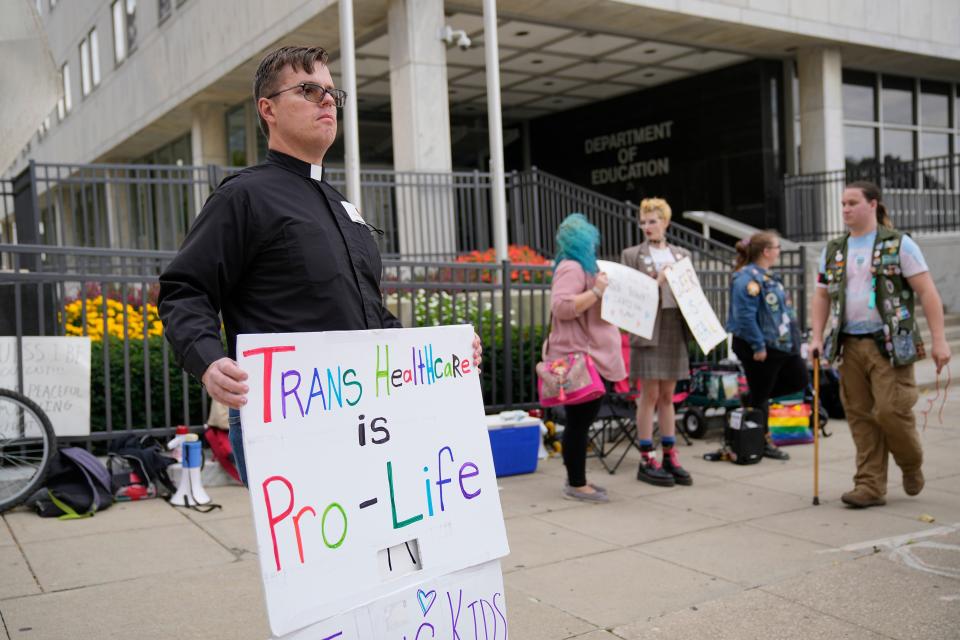 King Avenue United Methodist Church associate pastor Andy Burns and LGBTQ+ allies protest on Oct. 12, 2022, outside the Ohio Department of Education building as the board hears public testimony on a resolution that opposes proposed changes to Title IX, the federal law that prohibited discrimination in schools on the basis of sex. Introduced by board member Brendan Shea, the resolution lays out an "unequivocal opposition" to the Biden Administration's proposal to expand Title IX's protections to gender identity and sexual orientation.