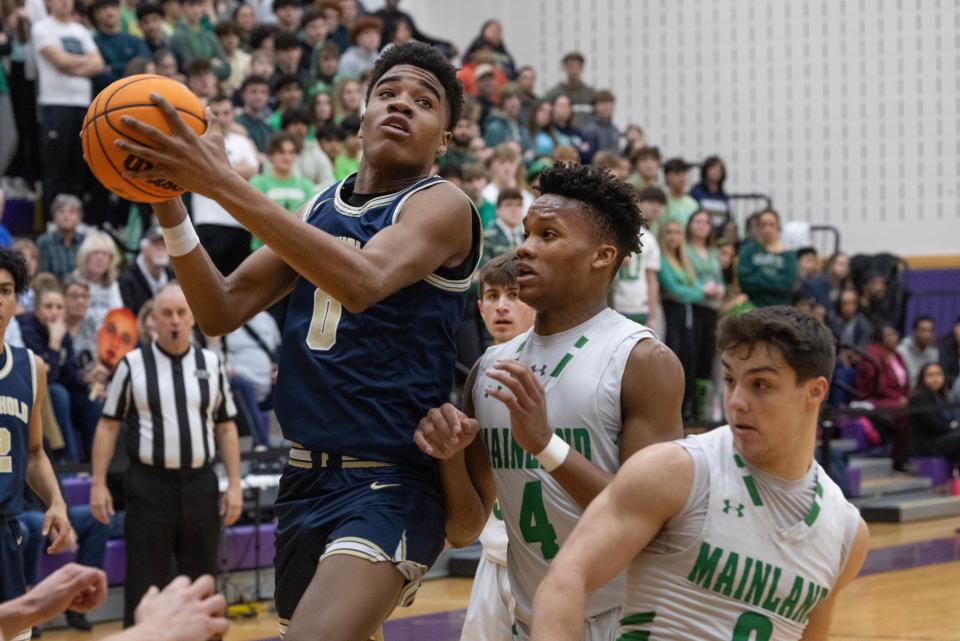 Freehold's Aidan Hamlin-Woolfolk goes up for a shot against Mainland's Jamie Tyson during the NJSIAA Group 3 Semifinals at Monroe High School on March 6, 2024.