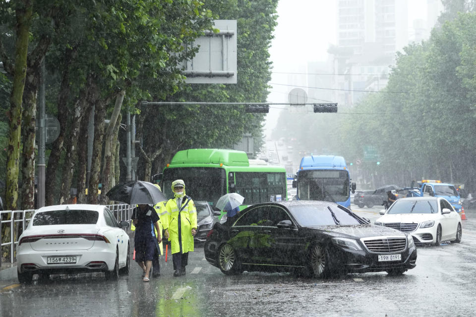 Vehicles, which had been submerged by the heavy rainfall, block a road in Seoul, South Korea, Tuesday, Aug. 9, 2022. Heavy rains drenched South Korea's capital region, turning the streets of Seoul's affluent Gangnam district into a river, leaving submerged vehicles and overwhelming public transport systems. (AP Photo/Ahn Young-joon)