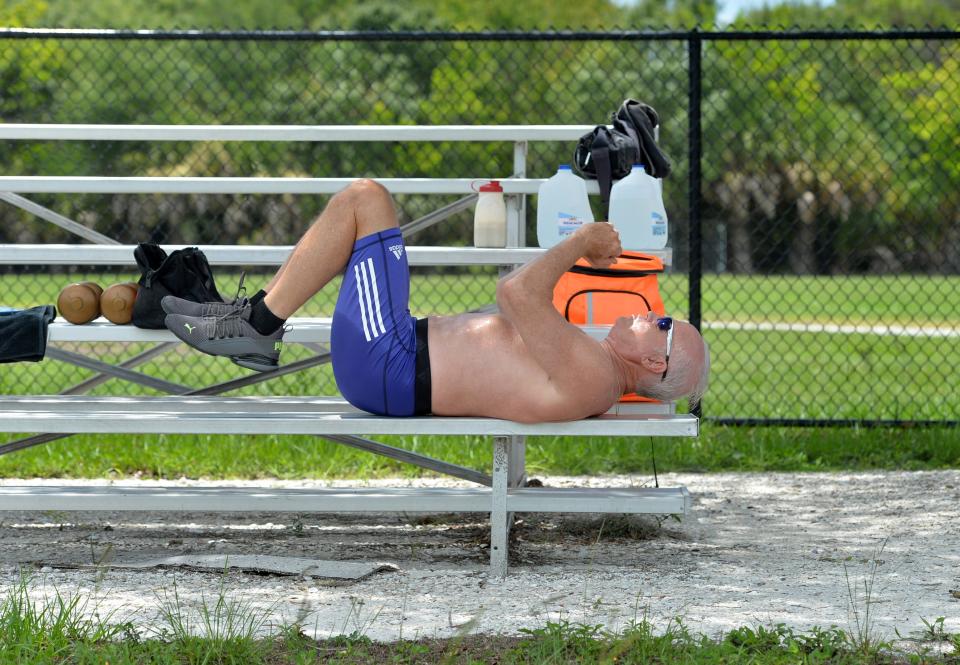 Mike Lynch does ab crunches as part of his training routine recently at the track at Pine View School in Osprey, Florida. At age 68, Lynch was recognized by Guinness World Records for having been the oldest man to play in a semi-pro or pro football game. He’s now 73, has a book out about his adventures, and still trains four times a week.